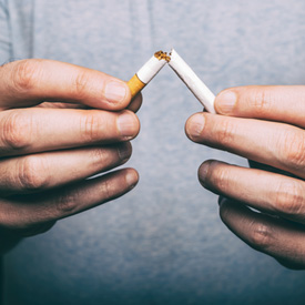 Man breaking a cigarette