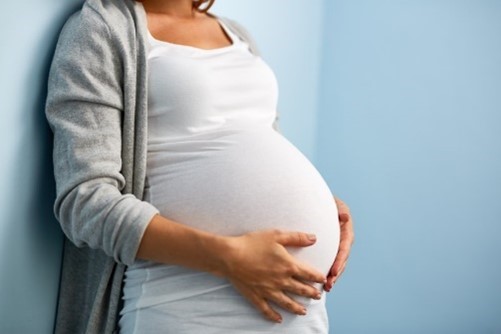 pregnant person holding stomach